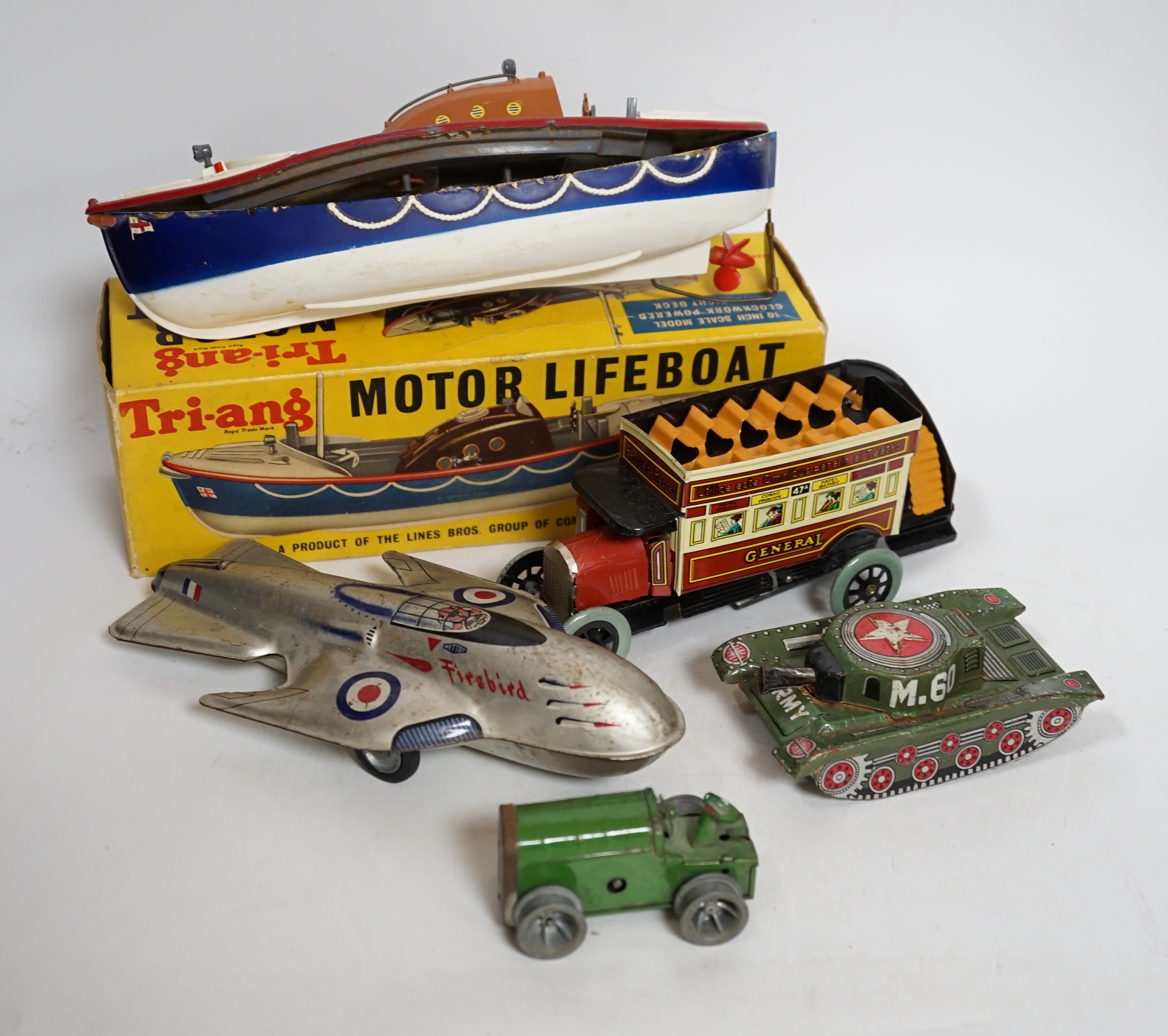 A collection of tinplate toys including cars, a fire engine, a Firebird jet plane, a Tri-ang lifeboat, an Tri-ang Minic tractor, etc. (11), together with a box of boardgames including Vintage Gibson and others; Bandit Ch